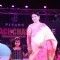 A guest with a child walk the ramp at the Teach for Change 2014 Fashion Show