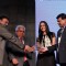 Neha Dhupia receives an award at Discon District Conference