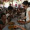 Kajol serves food to Rani Mukherjee at a Durga Pooja pandal in Mumbai